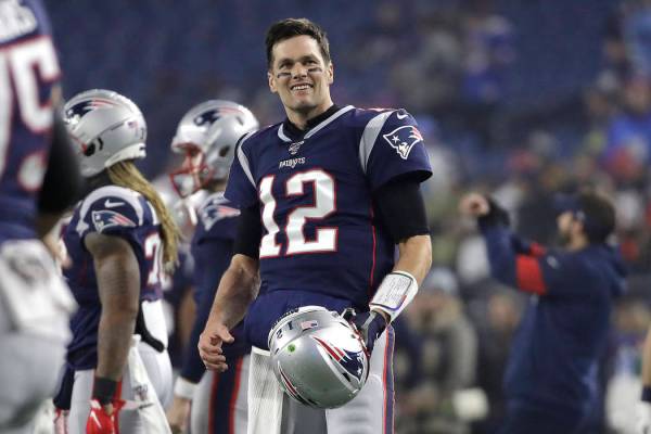 New England Patriots quarterback Tom Brady warms up before an NFL wild-card playoff football ga ...