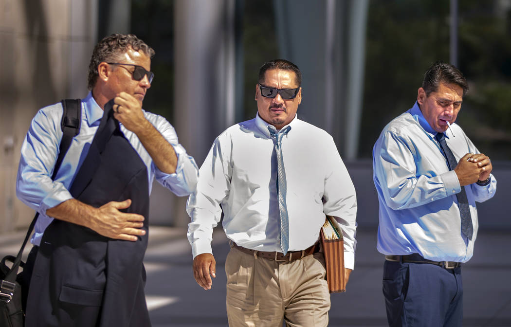 Counselor Mark Fleming, left, walks out with defendant Albert Lopez and past defendant Bradley ...