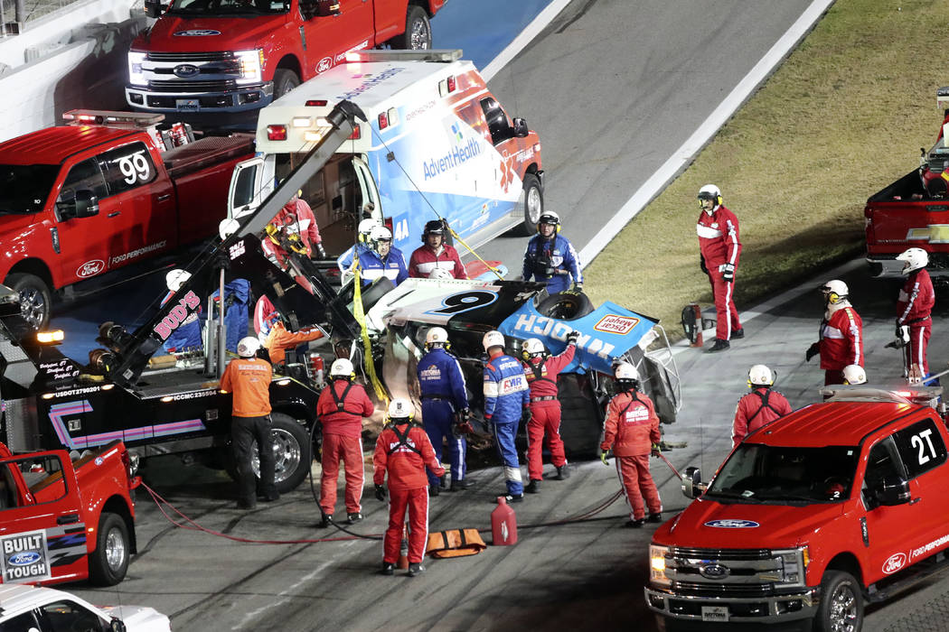 Rescue aid Ryan Newman after he was involved in a wreck on the last lap of the NASCAR Daytona 5 ...
