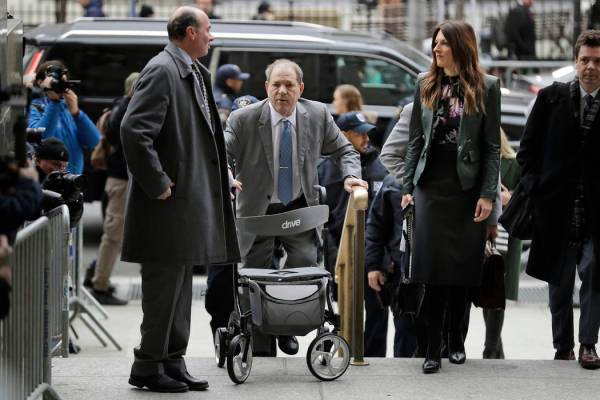 Harvey Weinstein, center, arrives at a Manhattan courthouse for his rape trial in New York, Tue ...