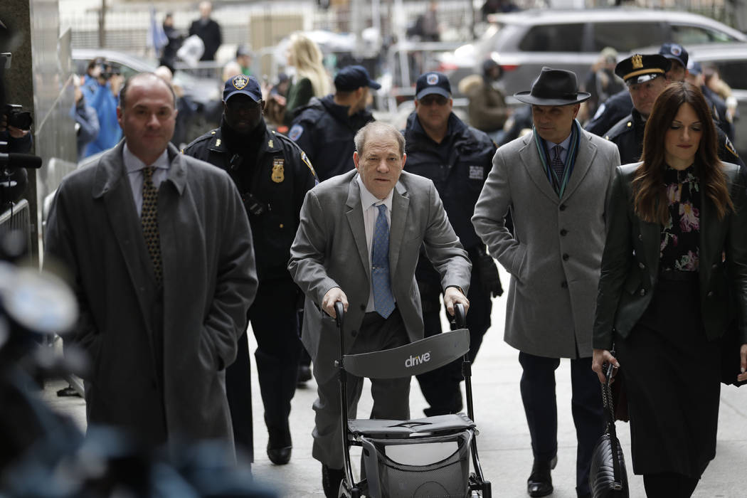 Harvey Weinstein, center, arrives at a Manhattan courthouse for his rape trial in New York, Tue ...