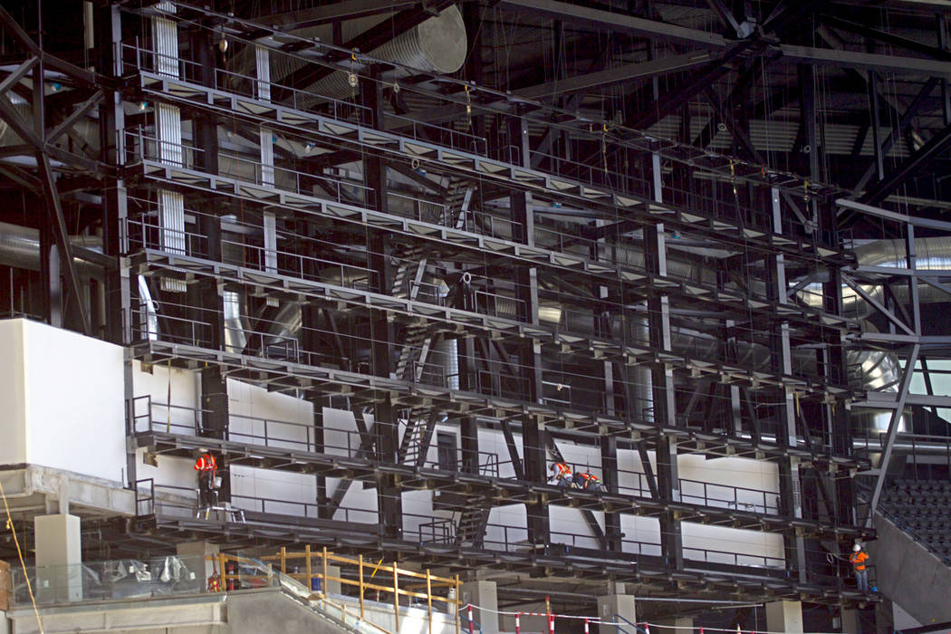 Crews install the support system for screens inside the Raiders Allegiant Stadium in Las Vegas, ...