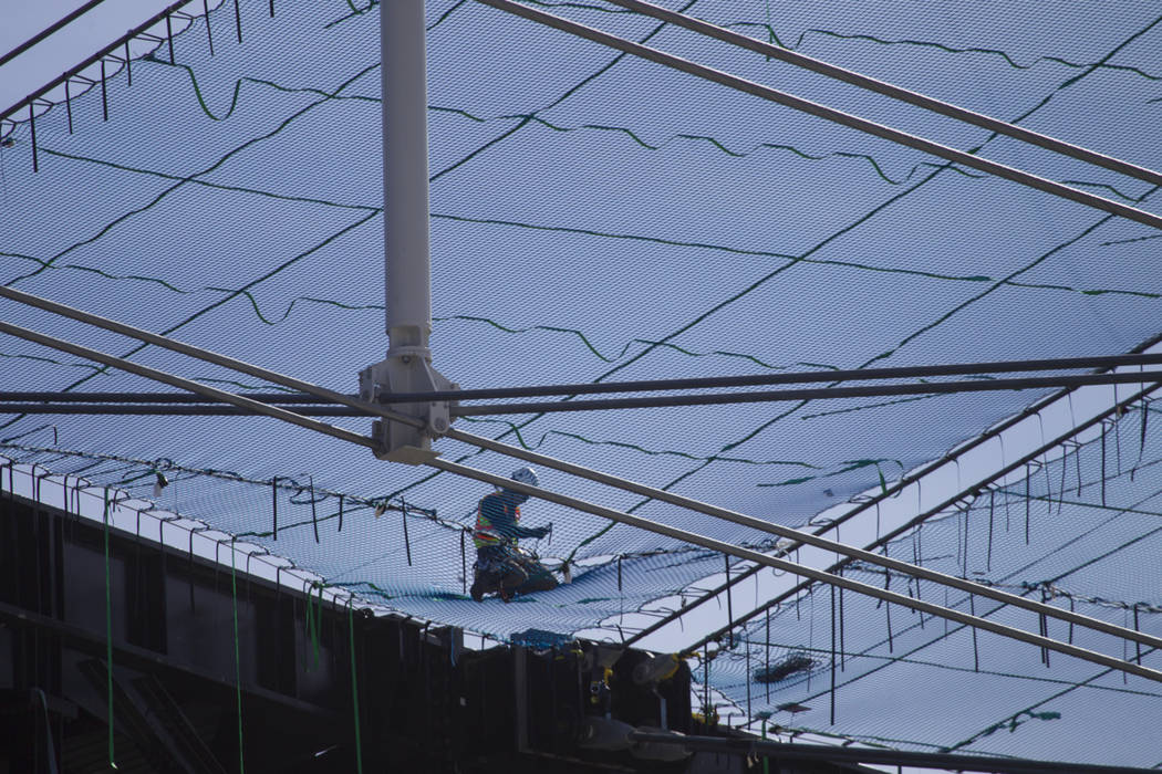 Netting is installed on top of the steel cable net system at the Raiders Allegiant Stadium in L ...