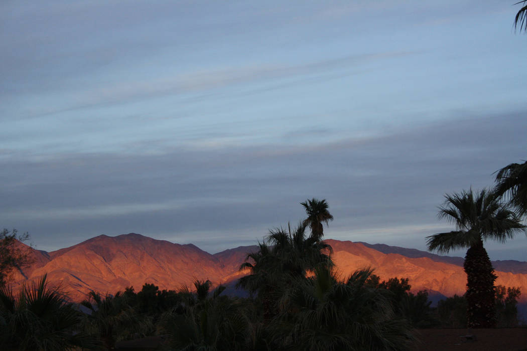 Sunset at Furnace Creek Ranch at Death Valley National Park, Calif., leaves the hillsides awash ...