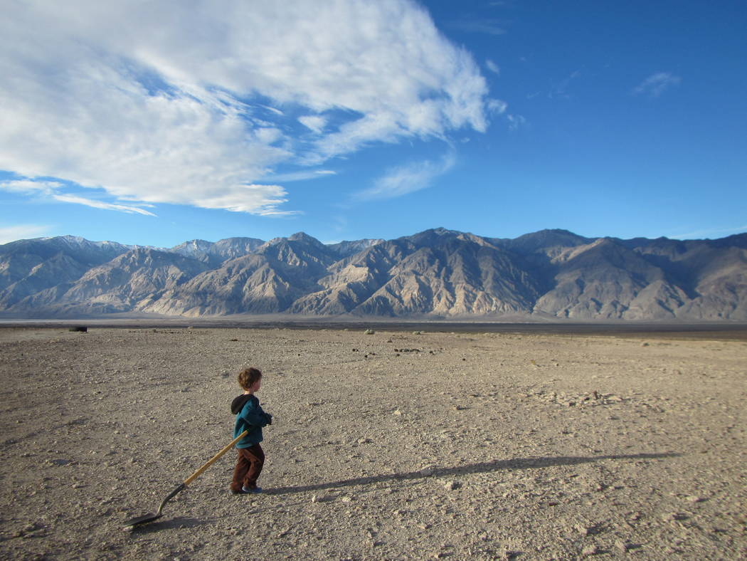A boy plays with a shovel in Saline Valley at Death Valley National Park on Jan. 18, 2015. ...