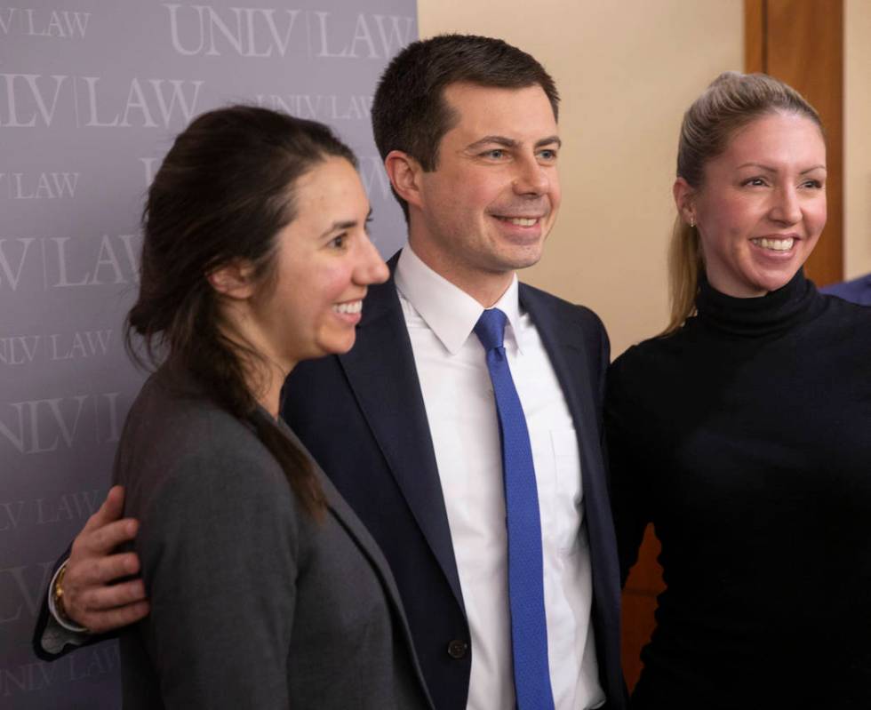 Democratic presidential candidate former South Bend Mayor Pete Buttigieg, middle, takes photos ...