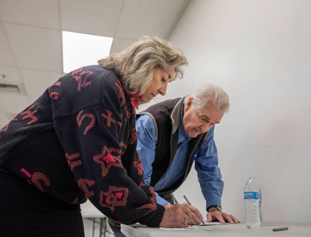 Rep. Dina Titus, D-Nev., left, and husband Thomas Wright cast their early vote at Cardenas Mark ...