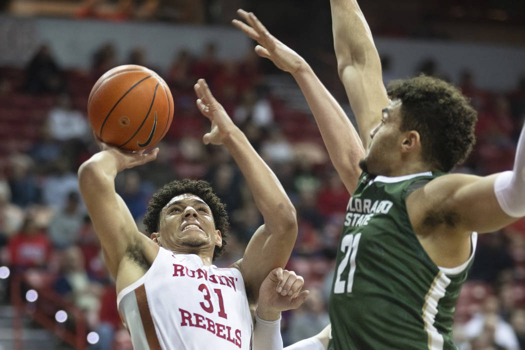 UNLV Rebels guard Marvin Coleman (31) drives past Colorado State Rams guard David Roddy (21) in ...