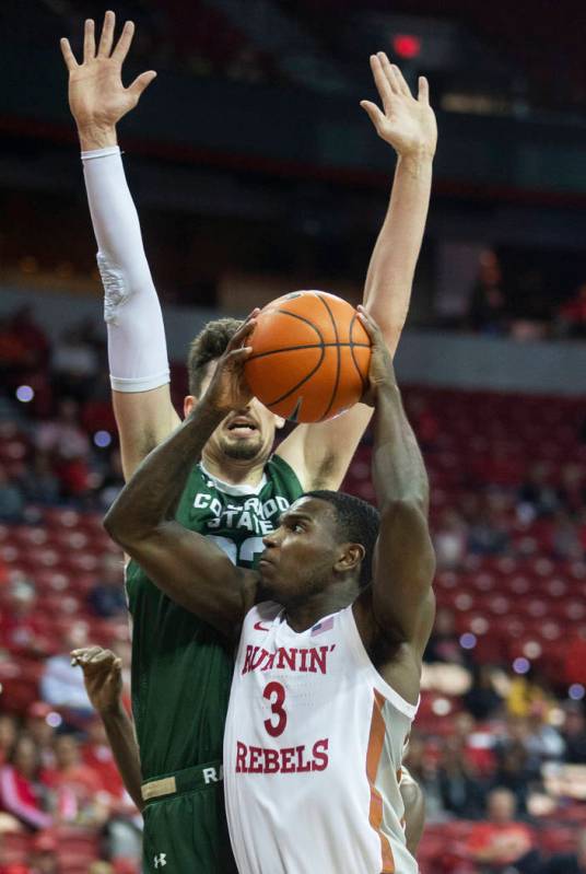 UNLV Rebels guard Amauri Hardy (3) drives past Colorado State Rams center Nico Carvacho (32) in ...