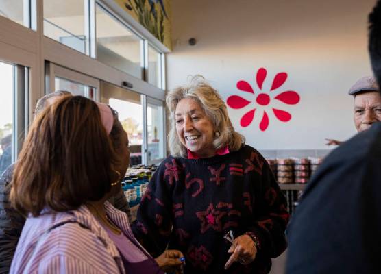 Rep. Dina Titus, D-Nev., greets LaSonia Dixon, 77, of North Las Vegas as they wait in line to c ...