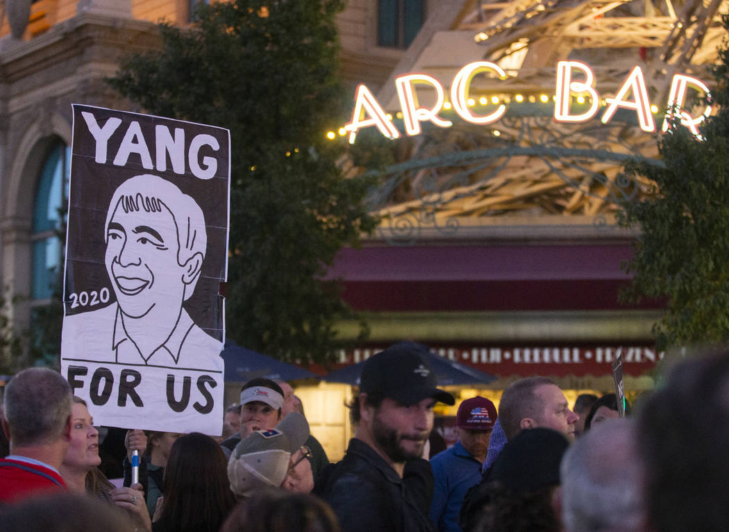 A supporter of former Democratic presidential candidate Andrew Yang holds a sign on the Strip o ...