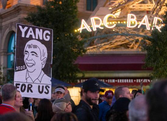 A supporter of former Democratic presidential candidate Andrew Yang holds a sign on the Strip o ...