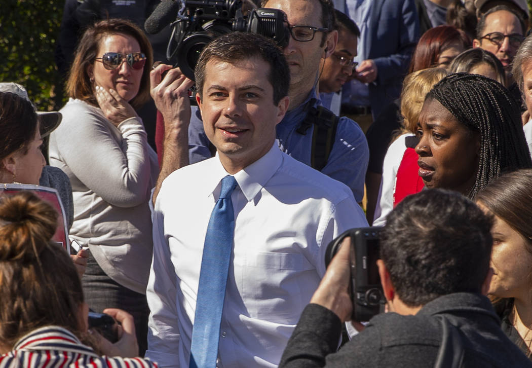 Democratic presidential candidate former South Bend, Ind. Mayor Pete Buttigieg talks with worke ...