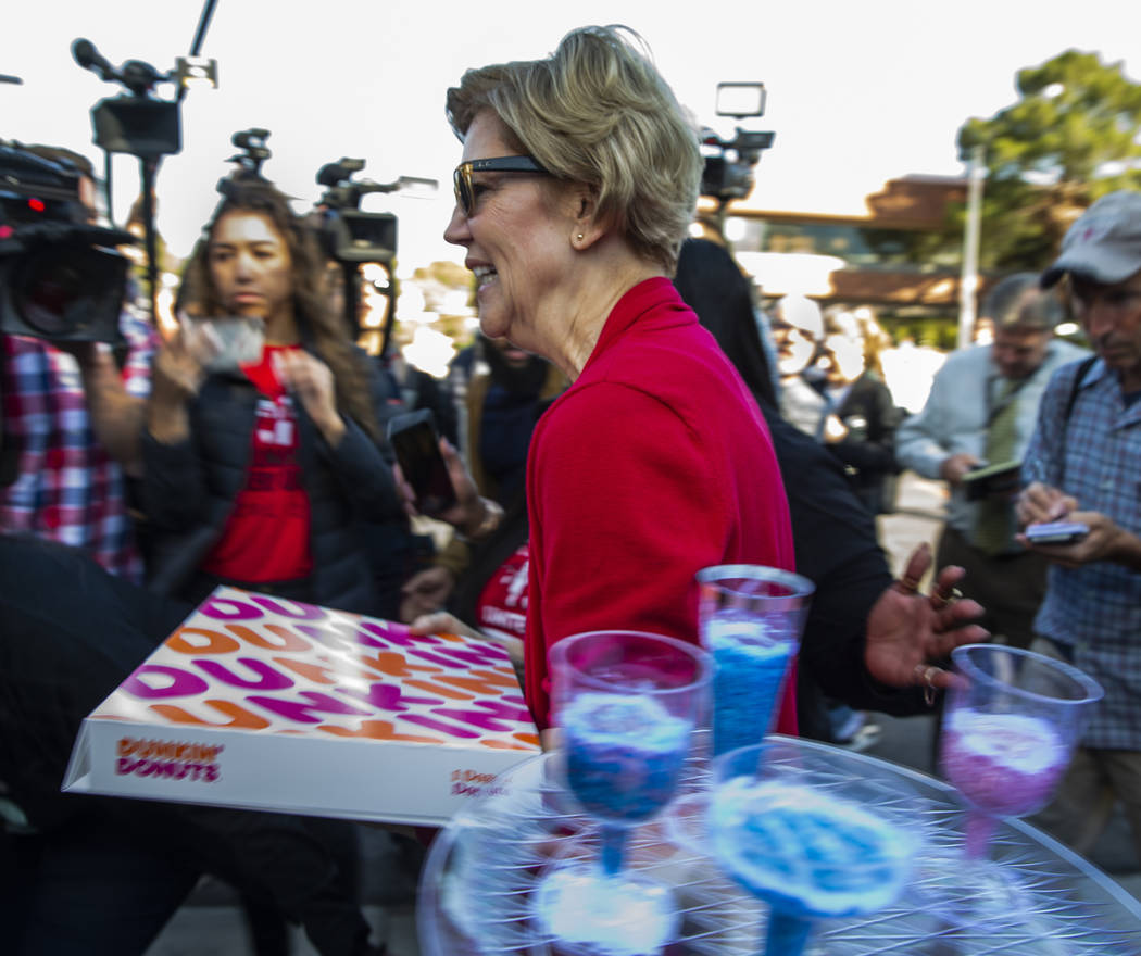 Democratic presidential candidate Sen. Elizabeth Warren, D-Mass. arrives with doughnuts for wor ...