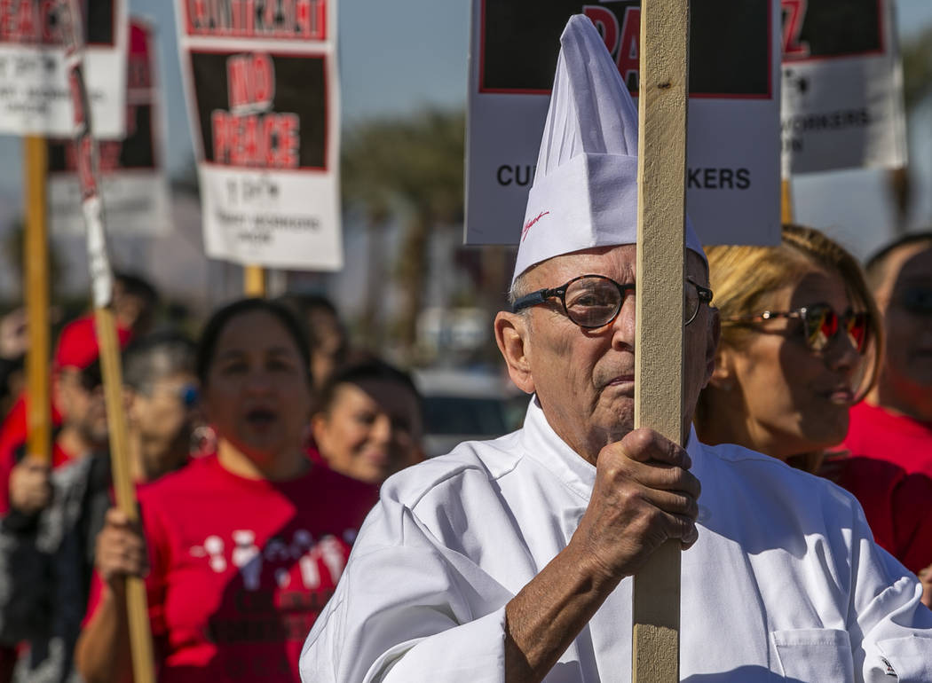Chef Richard Marushok carries a sign with other workers from seven Station Casinos' properties ...