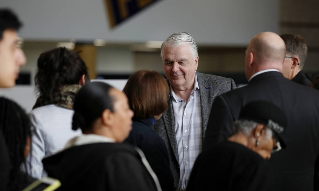Nevada Governor Steve Sisolak greets caucus participants at Cheyenne High School in North Las V ...