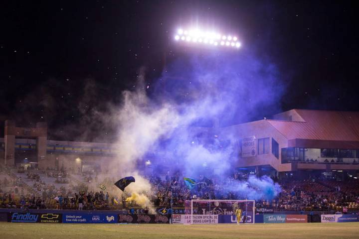 Fans cheer for a first half goal in the stands behind Las Vegas FC goalkeeper Thomas Olsen (30) ...