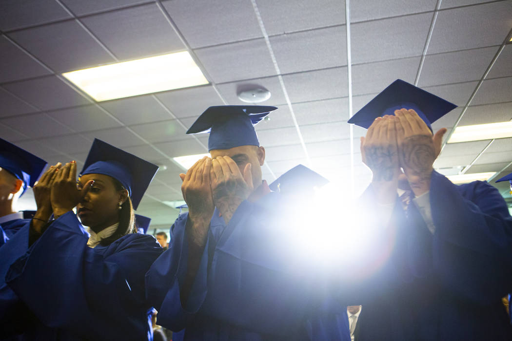 Graduating participants of the Hope for Prisoners program pray at Metropolitan Police Departmen ...