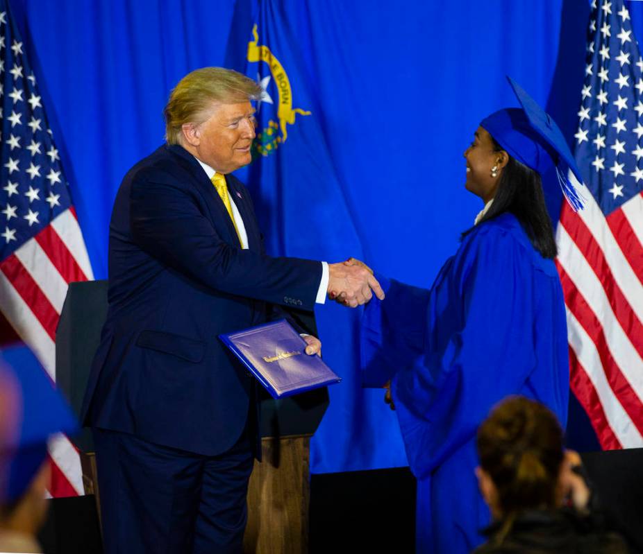 President Donald Trump hands out diplomas during a graduation ceremony for participants of the ...