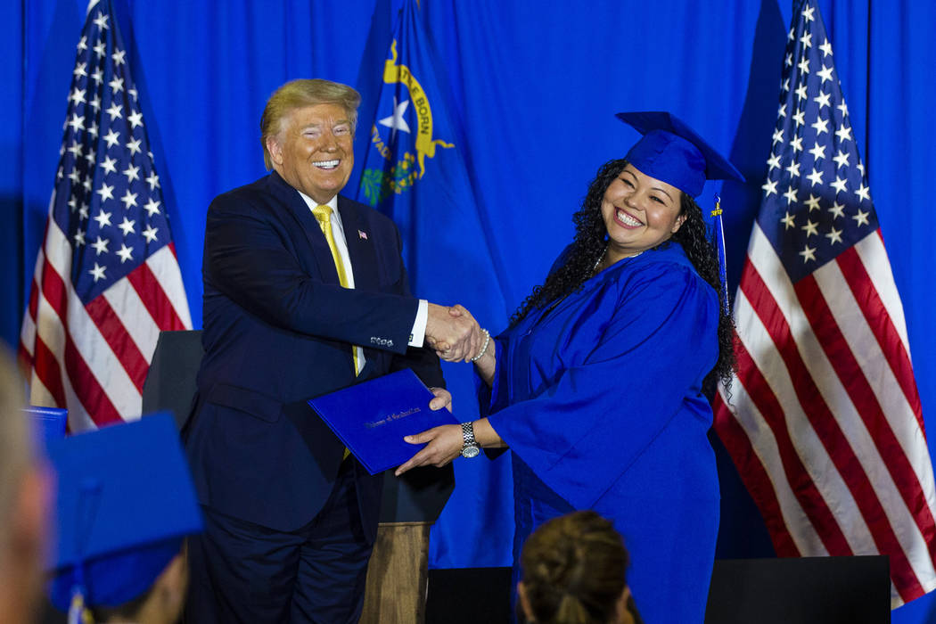 President Donald Trump hands out diplomas during a graduation ceremony for participants of the ...