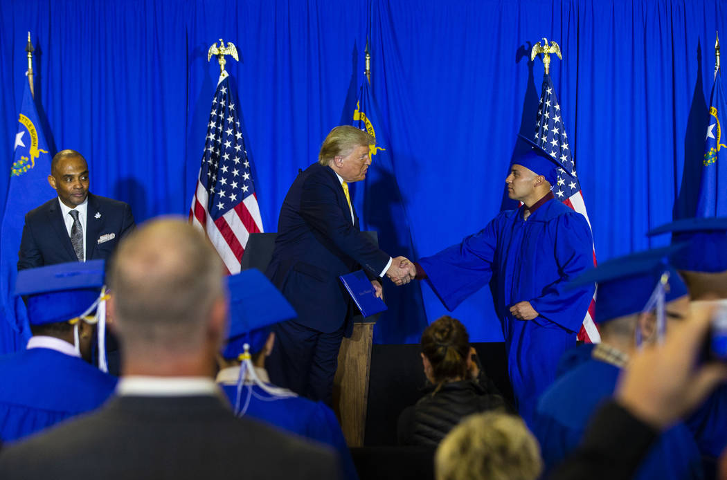 President Donald Trump hands out diplomas during a graduation ceremony for participants of the ...