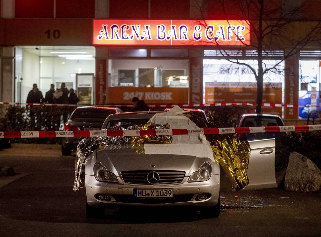 A car with dead bodies stands in front of a bar in Hanau, Germany, Thursday, Feb. 20, 2020. Ger ...