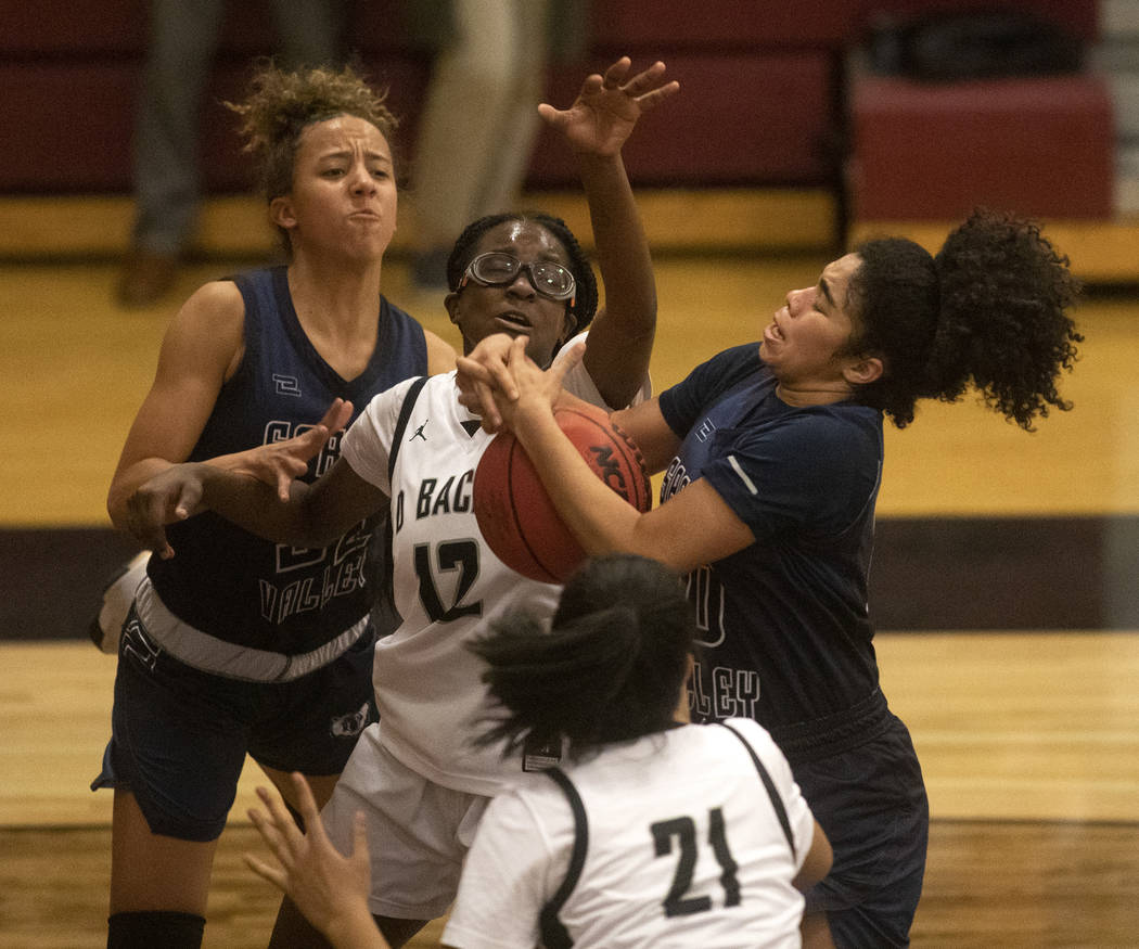 Desert Oasis's Jordyn Stroud (12) competes for the ball after a free throw with Spring Valley's ...