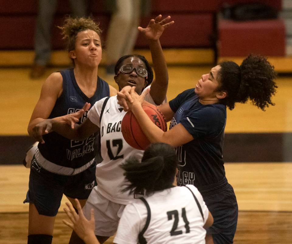 Desert Oasis's Jordyn Stroud (12) competes for the ball after a free throw with Spring Valley's ...