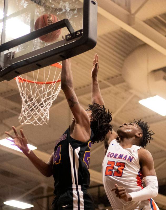 Bishop Gorman's Mwani Wilkinson (23) reaches to block a point by Durango's Kendrick Gilbert (24 ...