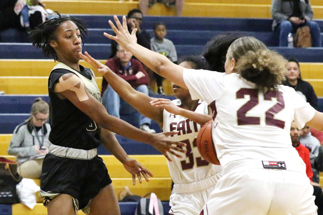 Spring Valley's Aaliyah Gayles (3) passes the ball between Faith Lutheran's Skye Chapman landa ...