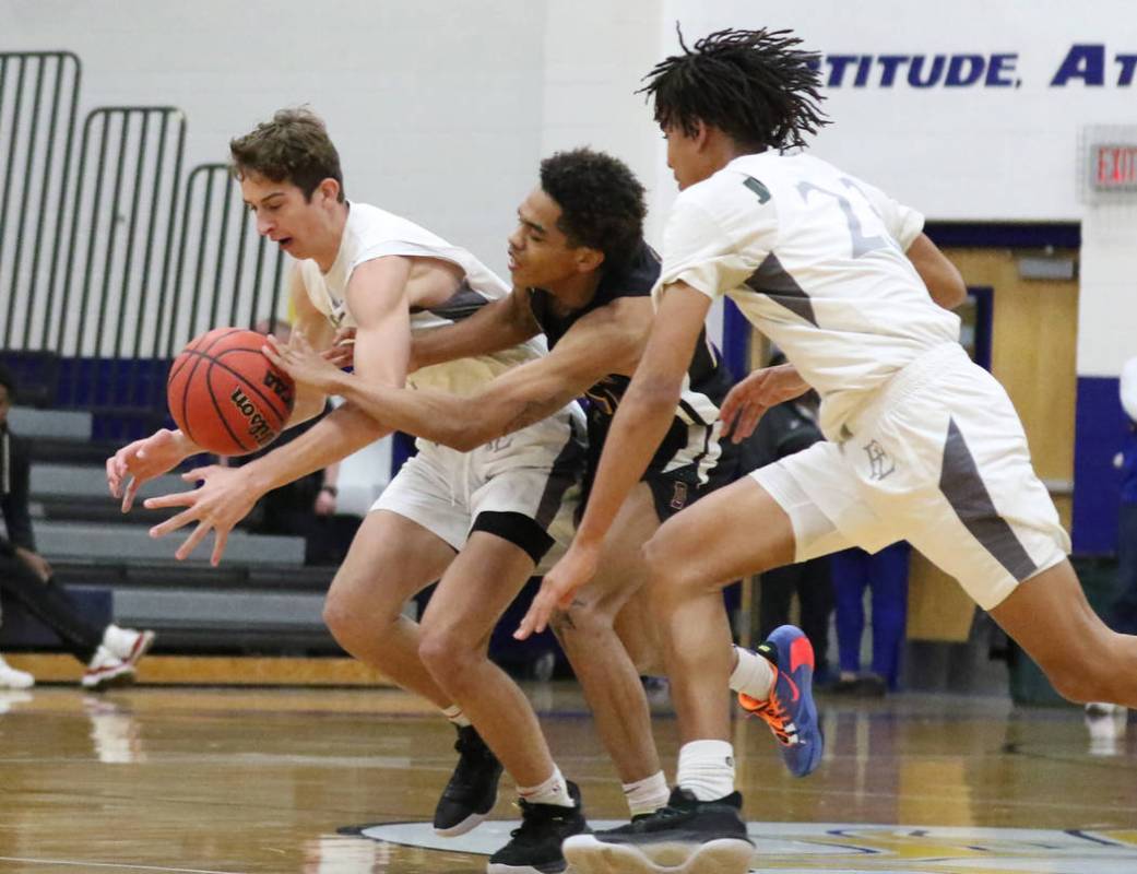 Faith Lutheran's Jason Sims, left, his teammate Jackson Williams (23) and Durango High's Anthon ...