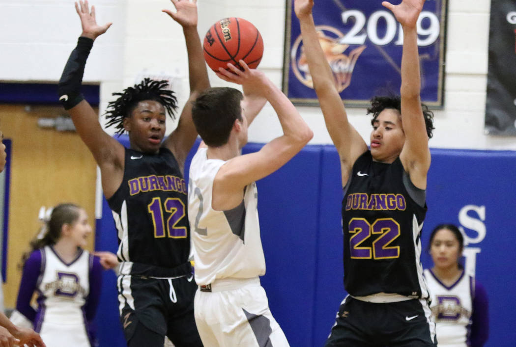 Durango High's Sebastian Mack (12) and Sterling Knox (22) defend Faith Lutheran's Max Heinz (22 ...