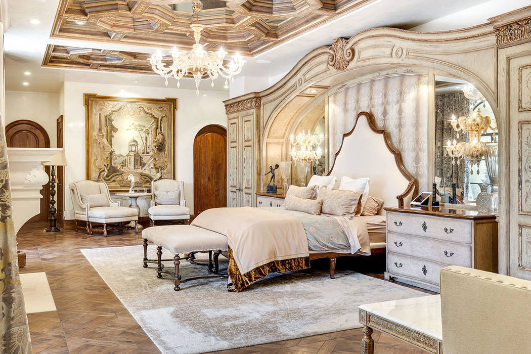 The master suite is a sprawling, multi-room space with a hand-painted elaborate ceiling design.