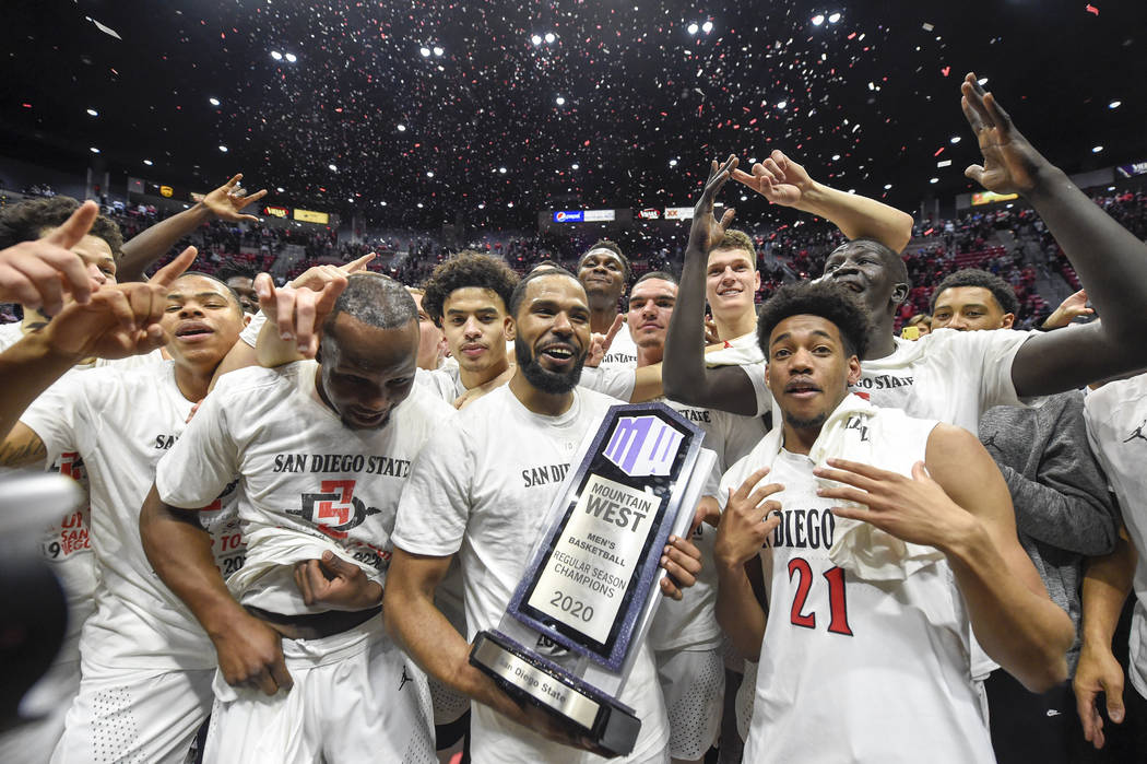San Diego State players celebrate after beating New Mexico 82-59 in an NCAA college basketball ...