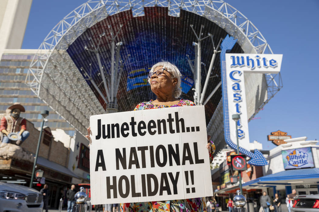 Opal Lee, 93, of Fort Worth, Texas, holds a sign on the Fremont Street Experience as part of a ...