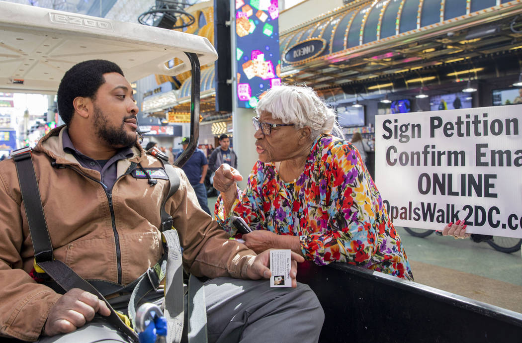 Opal Lee, 93, of Fort Worth, Texas, talks with Shamar Henderson, of Las Vegas, while walking th ...