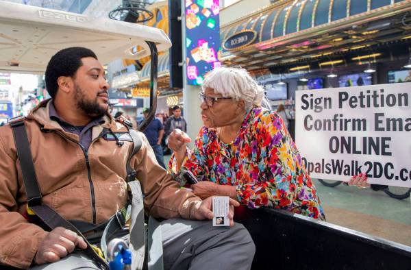 Opal Lee, 93, of Fort Worth, Texas, talks with Shamar Henderson, of Las Vegas, while walking th ...