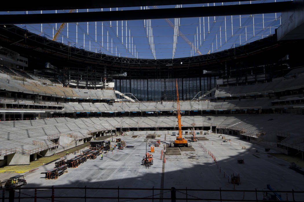 Construction crews on the field level of the the Raiders Allegiant Stadium in Las Vegas, Tuesda ...