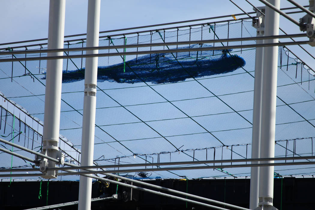 Netting is installed on top of the steel cable net system at the Raiders Allegiant Stadium in L ...