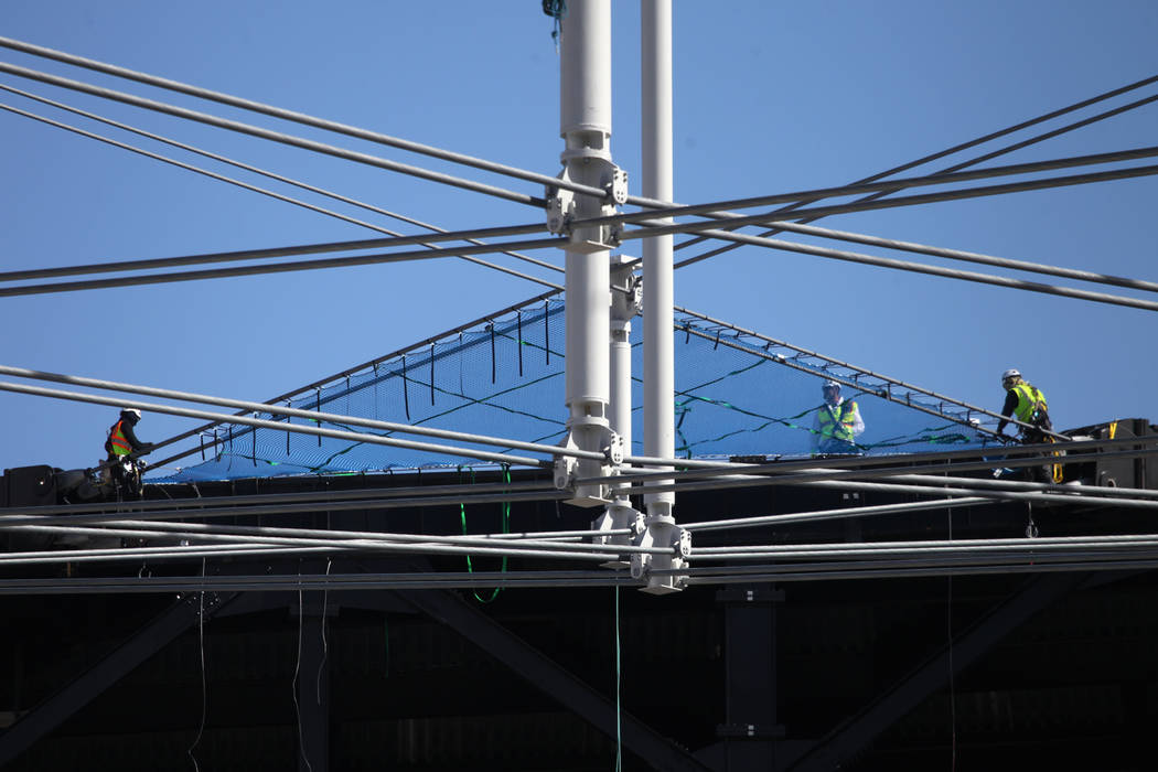 Netting is installed on top of the steel cable net system at the Raiders Allegiant Stadium in L ...