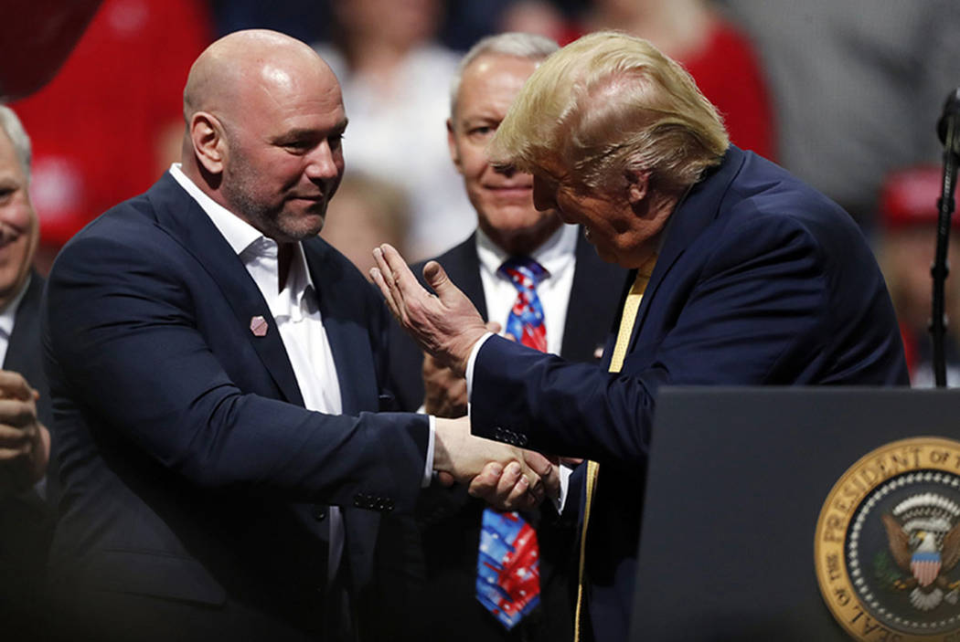 President Donald Trump, right, greets Dana White, head of the Ultimate Fighting Championship, a ...