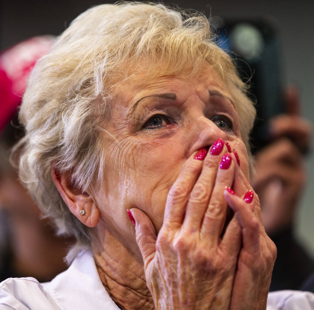 A supporter of President Donald Trump, not pictured, tears up while listening to him speak duri ...