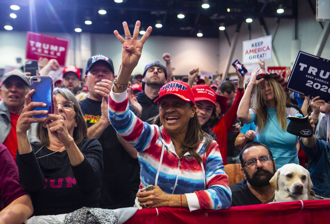 Supporters of President Donald Trump, not pictured, cheer as Vice President Mike Pence speaks a ...