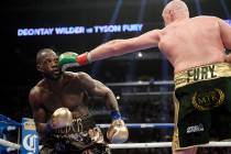 Tyson Fury, right, of England, connects with Deontay Wilder during a WBC heavyweight championsh ...