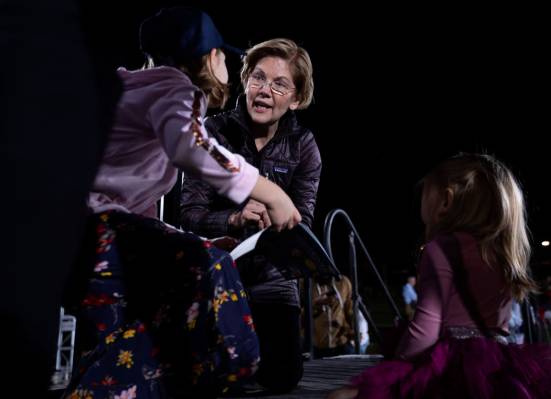 Sen. Elizabeth Warren, D-Mass., signs a presidential book of two young girls after the "Ge ...