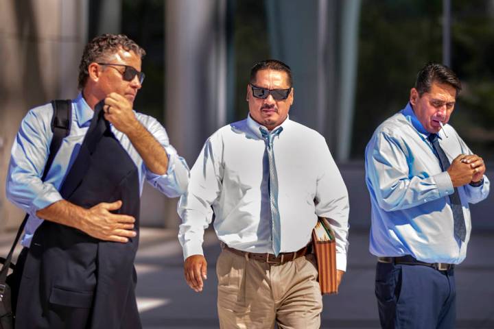 Attorney Mark Fleming, left, walks out with defendant Albert Lopez and past defendant Bradley C ...