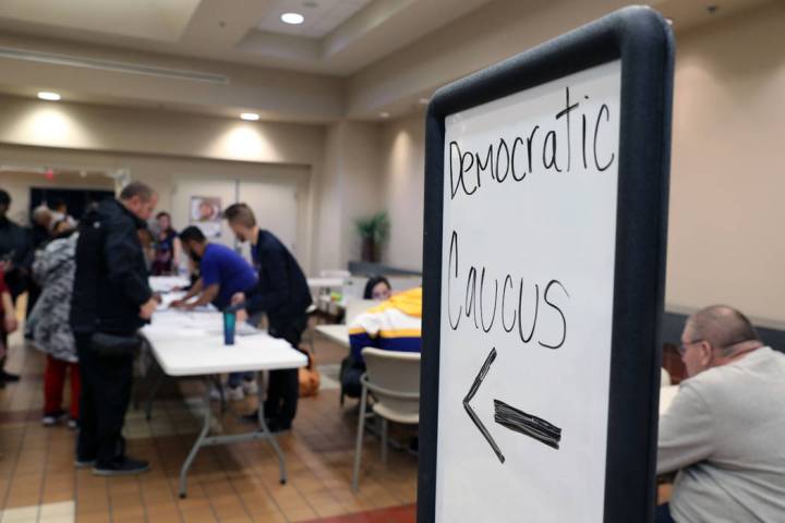 Individuals wait in line to register to caucus at the East Las Vegas Community Center in Las Ve ...