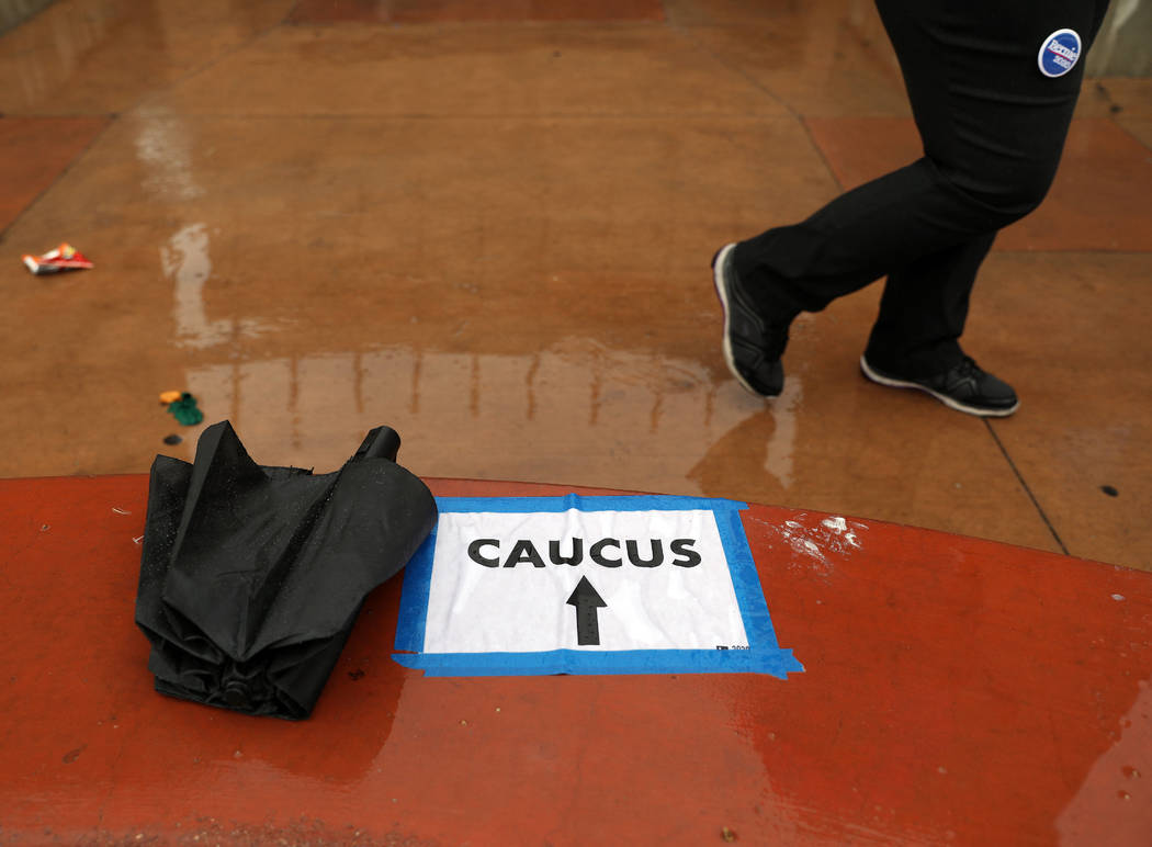 Rain falls as individuals arrive to register for the caucus at the East Las Vegas Community Cen ...