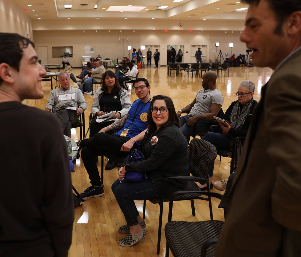 Caucus participants sit in their precinct groups about an hour before the caucus begins at the ...