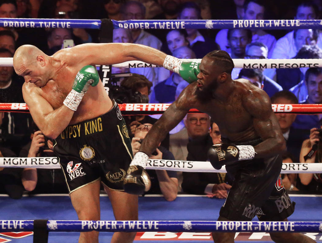 Deontay Wilder, right, connects with a right hook against Tyson Fury in the fourth round during ...
